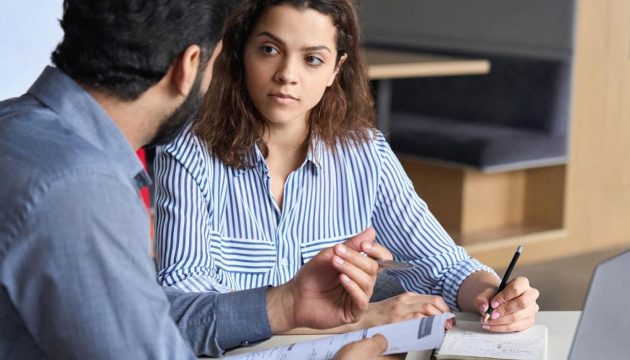 HR manager interviewing a candidate in a modern UAE office setting